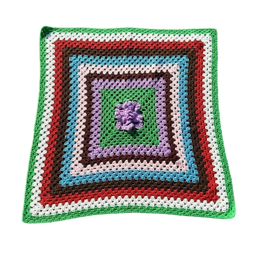 Vintage multicolor crocheted baby blanket with purple flower in center 37